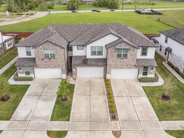 view of front of house featuring brick siding, driveway, and a garage