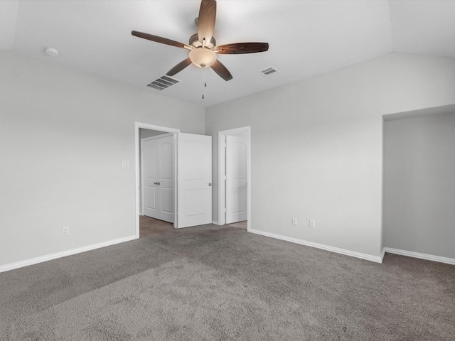 unfurnished bedroom with lofted ceiling, visible vents, and carpet flooring