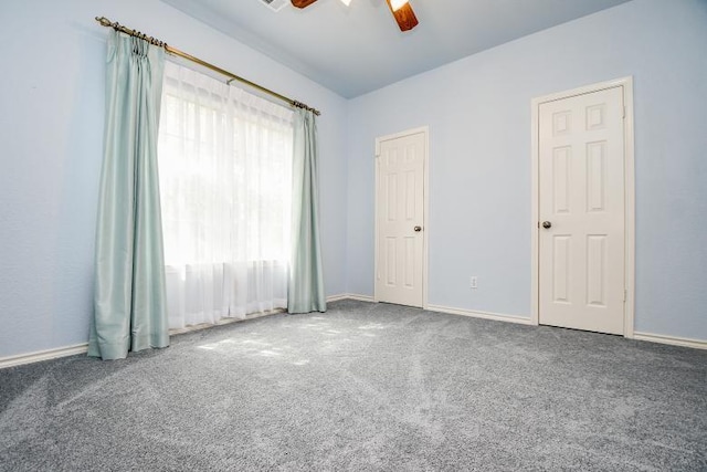 spare room with ceiling fan, carpet flooring, and baseboards