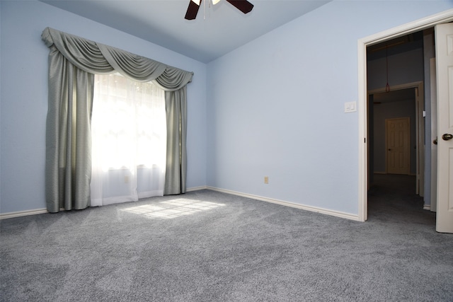 empty room with a ceiling fan, carpet floors, lofted ceiling, and baseboards