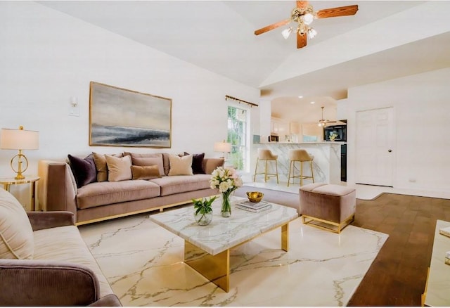 living area with vaulted ceiling, ceiling fan, and wood finished floors