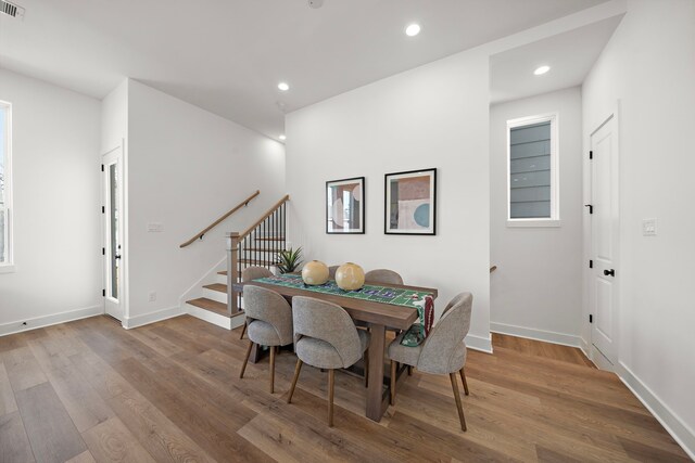 835 Rachel St Unit C, Houston, TX 77091 - dining area with baseboards, stairs, wood finished floors, and recessed lighting