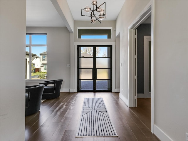10114 Mariner Oaks Dr, Missouri City, TX 77459 - foyer entrance featuring baseboards, dark wood-style floors, and an inviting chandelier