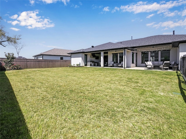 10114 Mariner Oaks Dr, Missouri City, TX 77459 - back of house with a patio area, stucco siding, fence, outdoor lounge area, and a yard