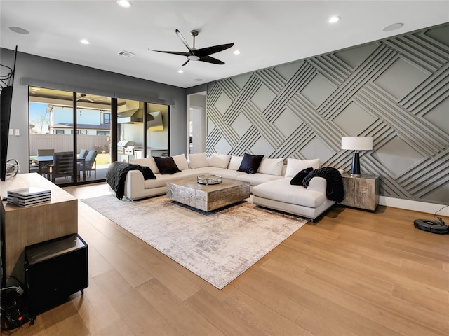 10114 Mariner Oaks Dr, Missouri City, TX 77459 - living area featuring recessed lighting, an accent wall, visible vents, a ceiling fan, and wood finished floors