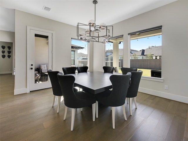 10114 Mariner Oaks Dr, Missouri City, TX 77459 - dining room with baseboards, visible vents, an inviting chandelier, and wood finished floors