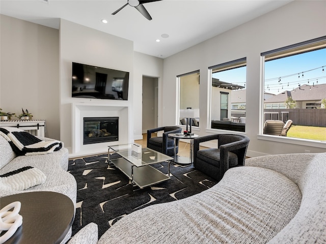 10114 Mariner Oaks Dr, Missouri City, TX 77459 - living area featuring baseboards, recessed lighting, a glass covered fireplace, and a ceiling fan