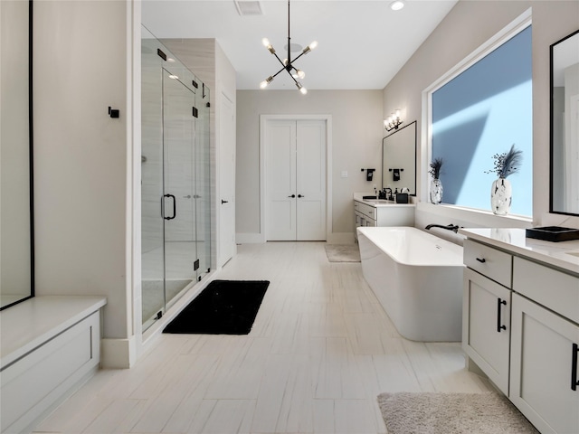 10114 Mariner Oaks Dr, Missouri City, TX 77459 - full bath featuring two vanities, a freestanding tub, a notable chandelier, and a shower stall