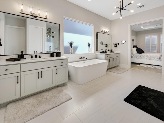 10114 Mariner Oaks Dr, Missouri City, TX 77459 - ensuite bathroom with a stall shower, a sink, a soaking tub, visible vents, and an inviting chandelier