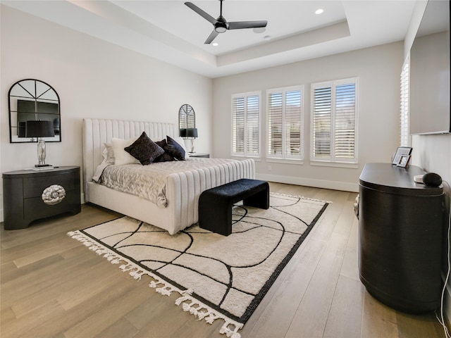 10114 Mariner Oaks Dr, Missouri City, TX 77459 - bedroom with recessed lighting, baseboards, a raised ceiling, ceiling fan, and light wood-style flooring