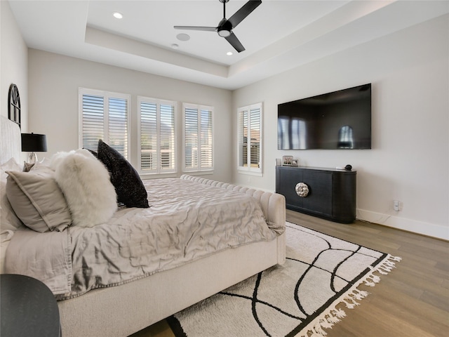 10114 Mariner Oaks Dr, Missouri City, TX 77459 - bedroom featuring baseboards, wood finished floors, recessed lighting, and a raised ceiling