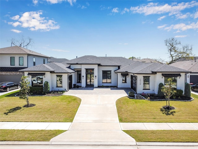 10114 Mariner Oaks Dr, Missouri City, TX 77459 - prairie-style home with roof with shingles, a front yard, stucco siding, and concrete driveway