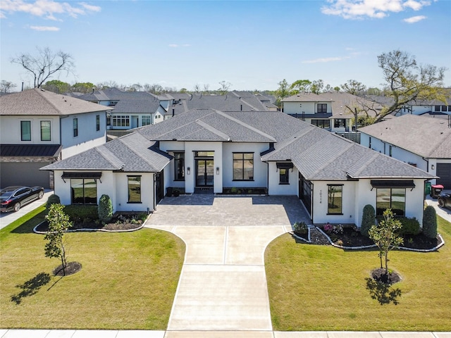 10114 Mariner Oaks Dr, Missouri City, TX 77459 - view of front of home with stucco siding, concrete driveway, roof with shingles, and a residential view