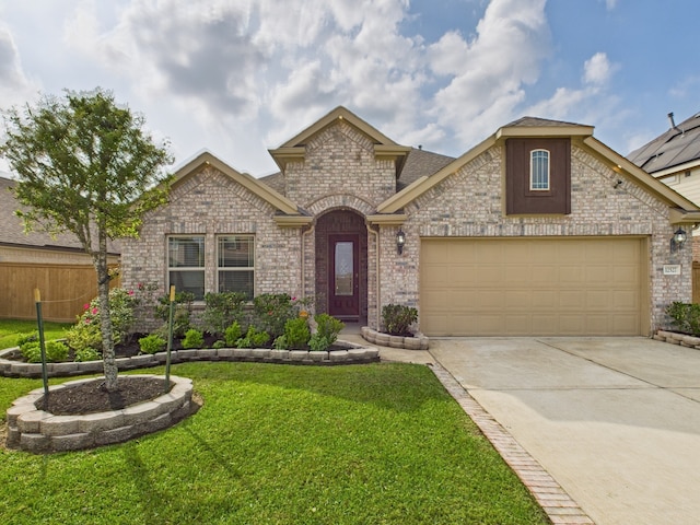 12527 Sabine Point Dr, Humble, TX 77346 - french provincial home featuring a front yard, an attached garage, concrete driveway, and brick siding