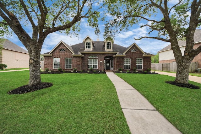 313 Overlook Dr, Friendswood, TX 77546 - view of front of property featuring brick siding, a front yard, a shingled roof, and fence
