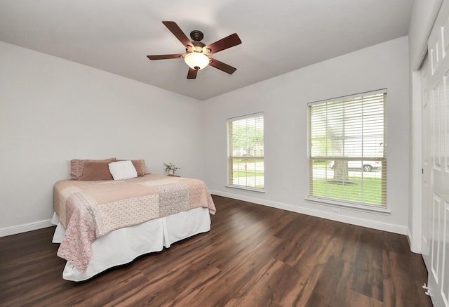 313 Overlook Dr, Friendswood, TX 77546 - bedroom with a closet, dark wood-style floors, baseboards, and a ceiling fan