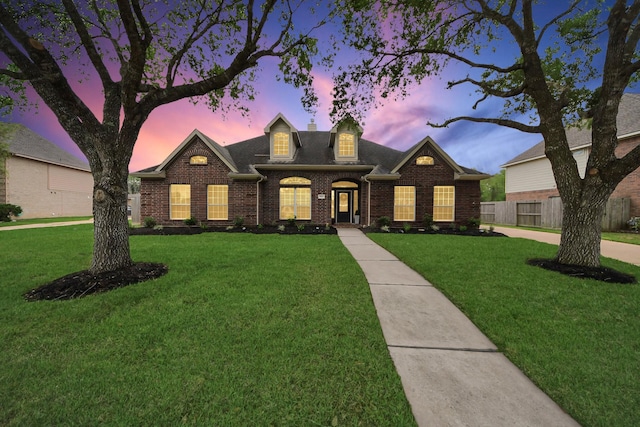 313 Overlook Dr, Friendswood, TX 77546 - view of front of home with brick siding, fence, a shingled roof, and a front yard