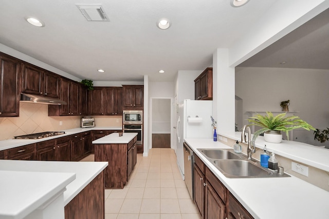 313 Overlook Dr, Friendswood, TX 77546 - kitchen with a sink, a center island, under cabinet range hood, stainless steel appliances, and visible vents