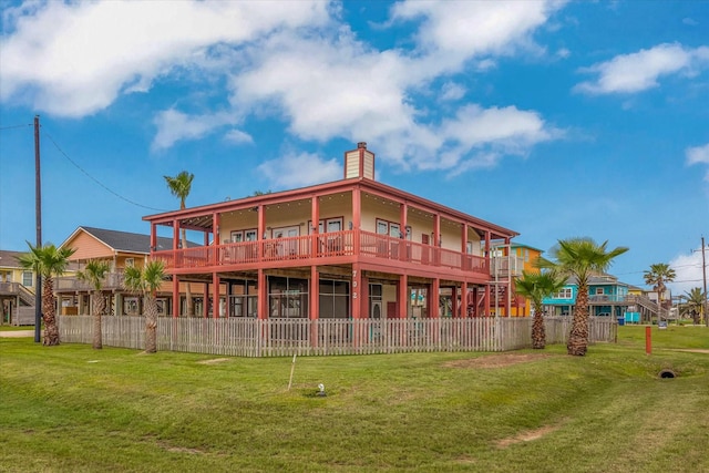 702 Surf Dr, Surfside Beach, TX 77541 - rear view of property featuring fence, a chimney, and a lawn