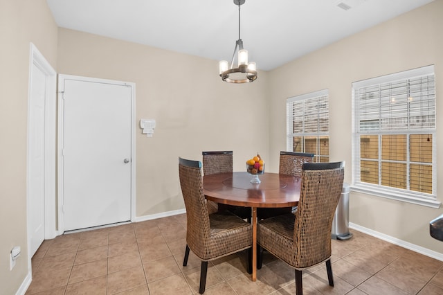dining room with light tile patterned floors, a chandelier, and baseboards