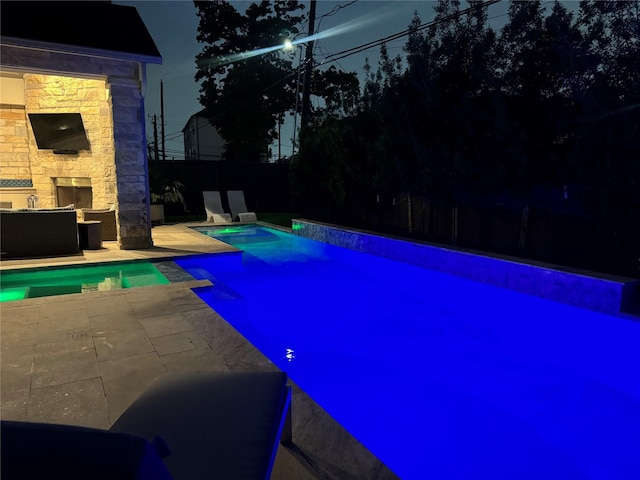 7526 Janak Dr, Houston, TX 77055 - view of pool featuring an outdoor stone fireplace, a patio area, and fence