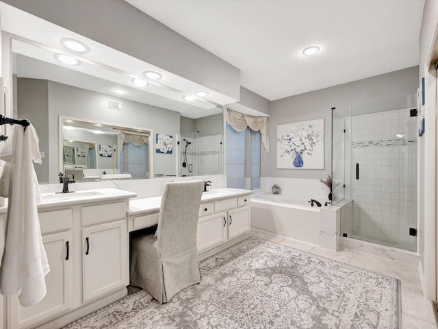bathroom featuring a bath, a sink, a shower stall, and two vanities