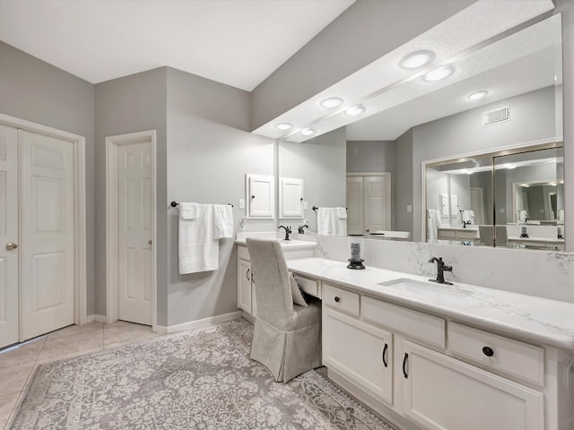 bathroom with baseboards, visible vents, tile patterned flooring, and vanity
