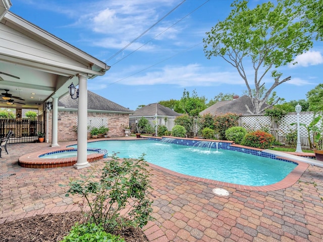 view of pool with a fenced backyard, a pool with connected hot tub, a patio area, and ceiling fan