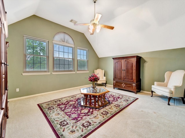 sitting room featuring light colored carpet, a ceiling fan, baseboards, and vaulted ceiling