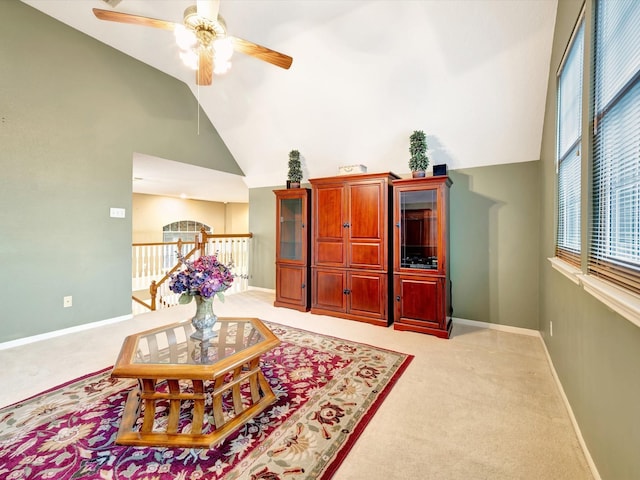living room with light carpet, baseboards, lofted ceiling, and ceiling fan