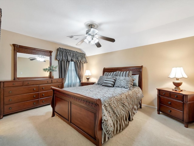 bedroom with a ceiling fan, lofted ceiling, light colored carpet, and visible vents