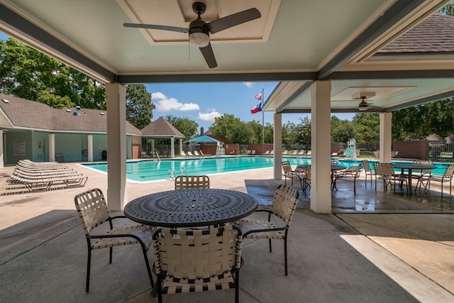 pool featuring fence, ceiling fan, and a patio area