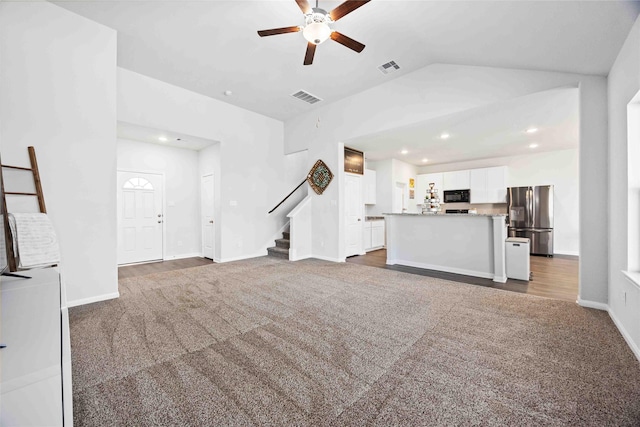 212 Bryan Way, Angleton, TX 77515 - unfurnished living room with carpet flooring, a ceiling fan, visible vents, and stairs