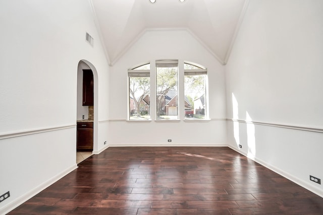 6423 Middlelake Ct, Katy, TX 77450 - spare room featuring wood-type flooring, arched walkways, lofted ceiling, and baseboards