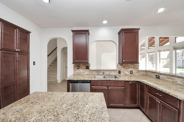 6423 Middlelake Ct, Katy, TX 77450 - kitchen with stainless steel dishwasher, light tile patterned floors, a sink, light stone counters, and recessed lighting