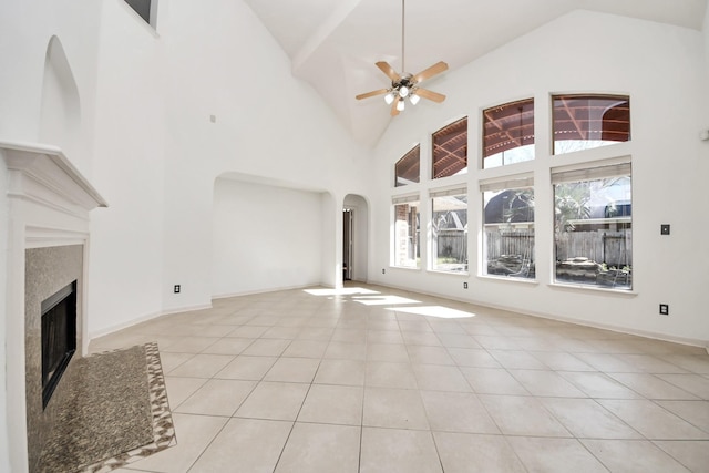 6423 Middlelake Ct, Katy, TX 77450 - unfurnished living room with arched walkways, ceiling fan, a fireplace, light tile patterned floors, and high vaulted ceiling