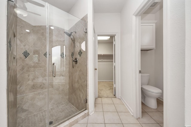 6423 Middlelake Ct, Katy, TX 77450 - bathroom with a shower stall, toilet, a spacious closet, tile patterned flooring, and baseboards