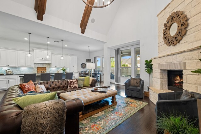19843 Quarry Stone Ln, Richmond, TX 77407 - living room featuring high vaulted ceiling, dark wood finished floors, a stone fireplace, recessed lighting, and beam ceiling