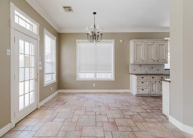 4135 Bellefontaine, Houston, TX 77025 - unfurnished dining area featuring a chandelier, stone tile flooring, baseboards, and crown molding