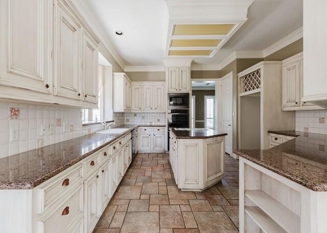 4135 Bellefontaine, Houston, TX 77025 - kitchen featuring appliances with stainless steel finishes, healthy amount of natural light, stone tile floors, a sink, and ornamental molding