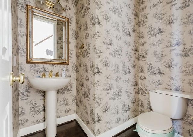 4135 Bellefontaine, Houston, TX 77025 - half bath with toilet, baseboards, and wood finished floors