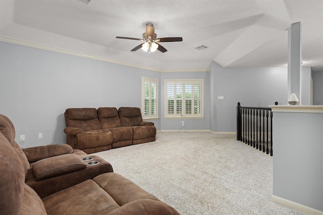 living room with baseboards, a textured ceiling, carpet floors, visible vents, and a ceiling fan