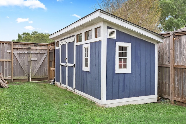 view of shed featuring fence