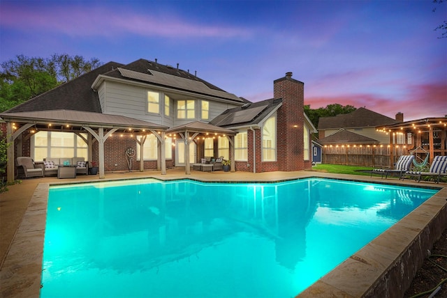 view of pool featuring a fenced in pool, a gazebo, outdoor lounge area, and a patio