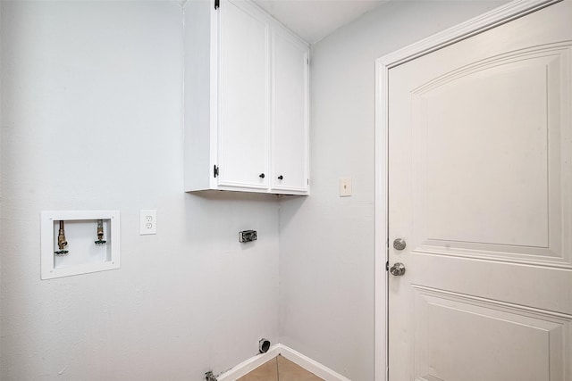 washroom featuring gas dryer hookup, washer hookup, baseboards, electric dryer hookup, and cabinet space