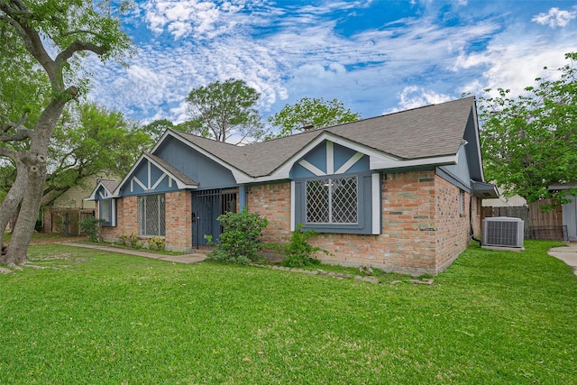 single story home featuring brick siding, central air condition unit, and fence
