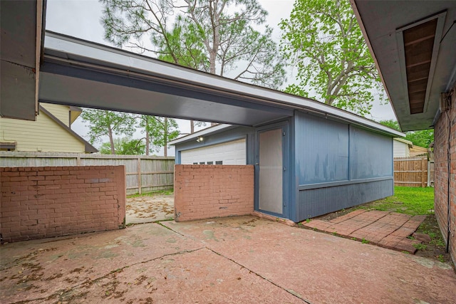 view of patio / terrace with a fenced backyard and an outbuilding
