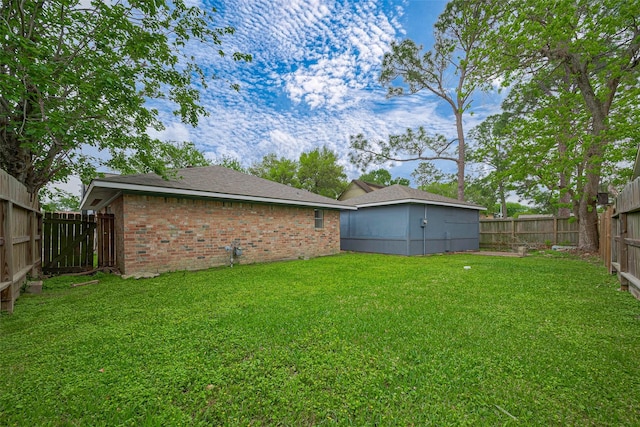 view of yard featuring a fenced backyard and an outdoor structure