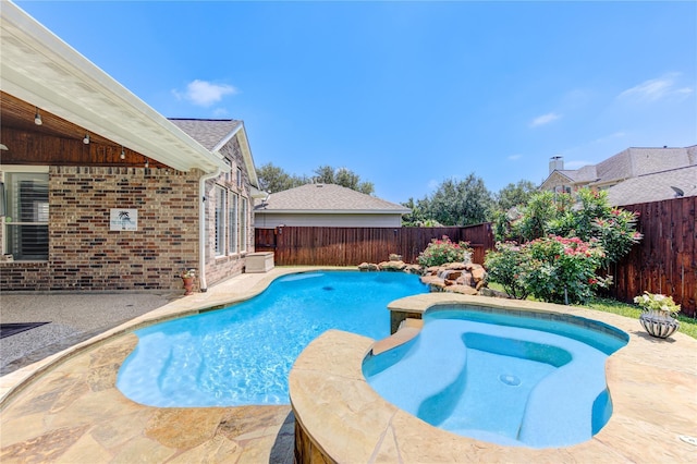 view of pool featuring a fenced backyard, a patio, and a pool with connected hot tub