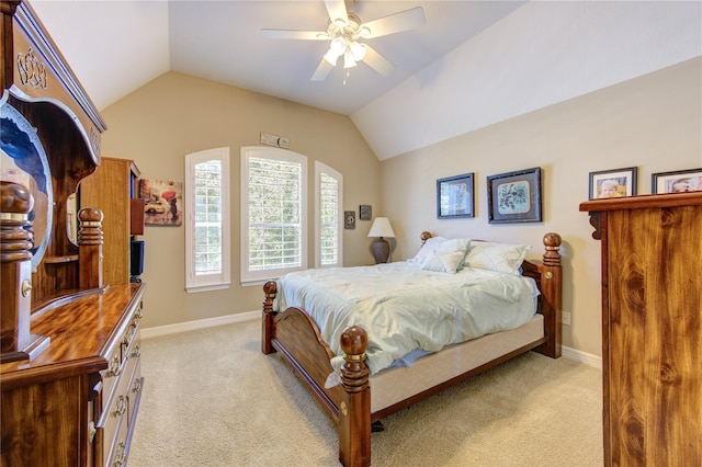bedroom featuring light carpet, vaulted ceiling, a ceiling fan, and baseboards